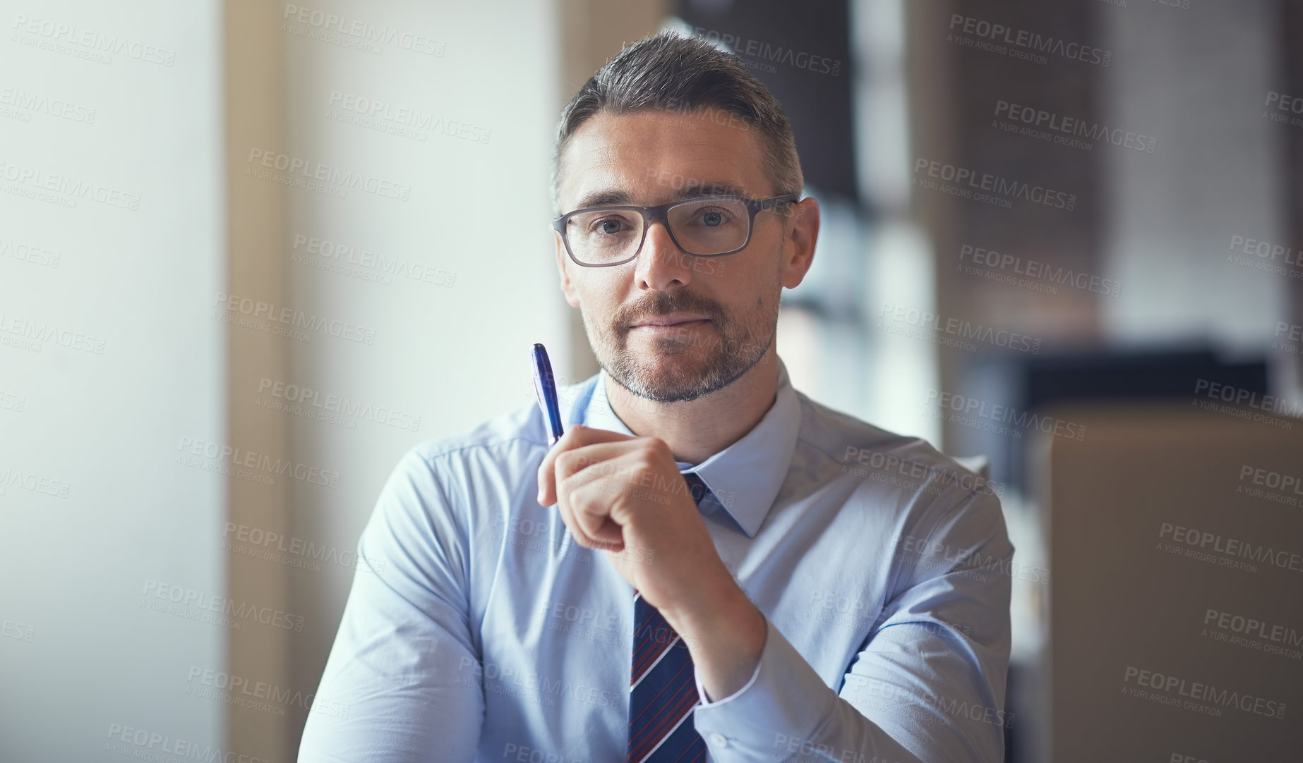 Buy stock photo Portrait of a businessman sitting at his desk