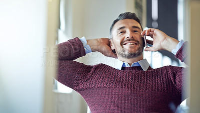 Buy stock photo Shot of a businessman talking on his cellphone at the office