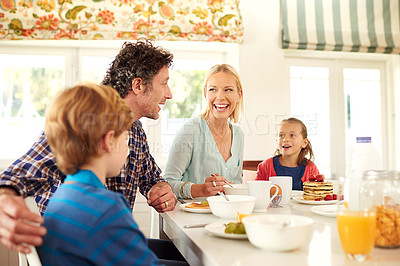 Buy stock photo Family, food and parents with children for breakfast, eating and bonding together in dining room. Smile, happy mother and father with young kids for healthy meal, nutrition and hunger in home