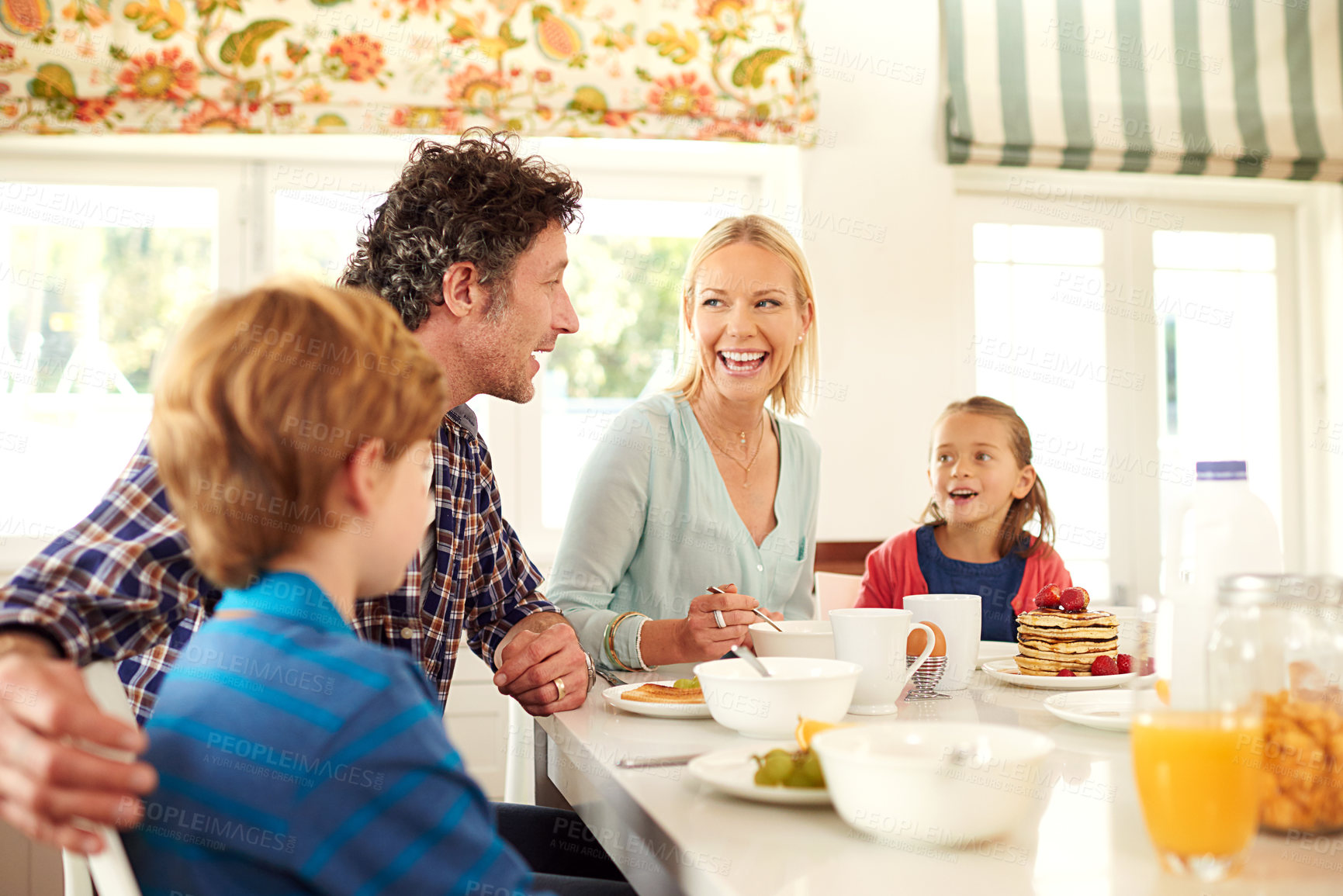 Buy stock photo Family, food and parents with children for breakfast, eating and bonding together in dining room. Smile, happy mother and father with young kids for healthy meal, nutrition and hunger in home