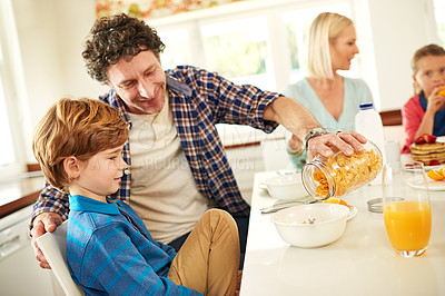 Buy stock photo Father, breakfast and boy in house for eating, happiness and kids at table in morning for nutrition. Dad, mom and wellness indoors for weekend fun, children and couple in kitchen for bonding