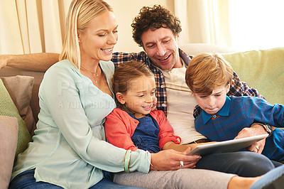 Buy stock photo Family, tech and together on couch for streaming with happiness, internet connection and rapport. Parents, young children and tablet on sofa in living room for watching with relax, online and smile