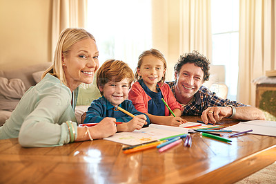 Buy stock photo Portrait of a family drawing and colouring in pictures together at home