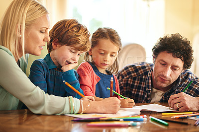 Buy stock photo Cropped shot of a family drawing and colouring in pictures together at home