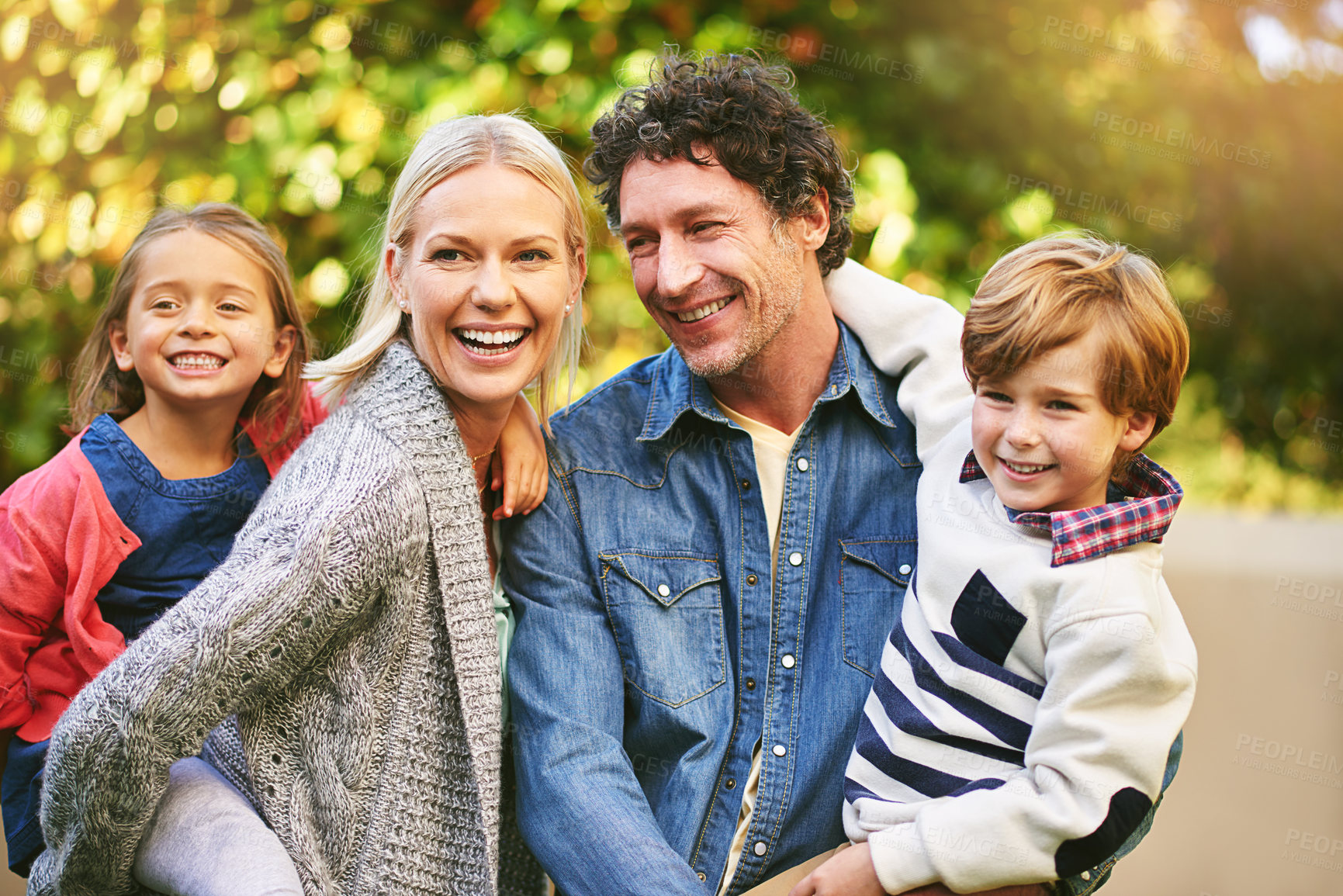 Buy stock photo Cropped shot of a happy family spending quality time together outside