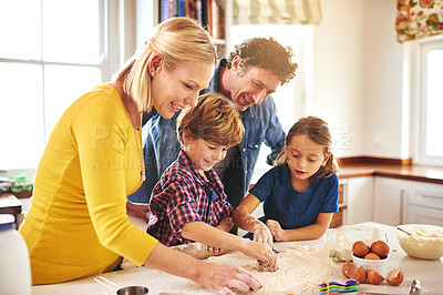 Buy stock photo Cropped shot of a family baking together at home