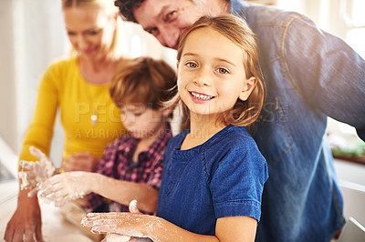 Buy stock photo Portrait of a young girl baking together with her family at home