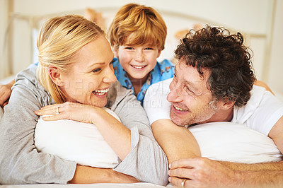 Buy stock photo Family, child and home on bed for love, embrace and bonding by having fun in the morning with pyjamas. Happy, mom and dad with kid hugging in bedroom for positive childhood memories as unity
