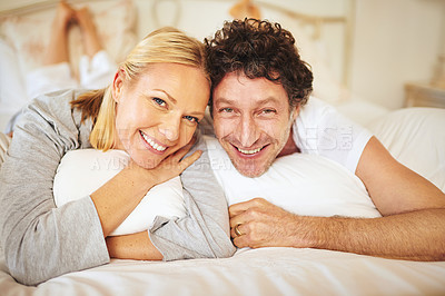 Buy stock photo Couple, smile and portrait in bedroom for relax and unwind on day off for break or holiday indoor. Woman, man and happy together for relationship, pyjama comfort and rest in house for in love   