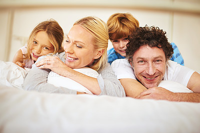 Buy stock photo Portrait, happy and family in bed with kids, parents and play for bonding in bedroom. Couple, children and smiles for together, love and support in home on weekend for relaxing, break and happiness