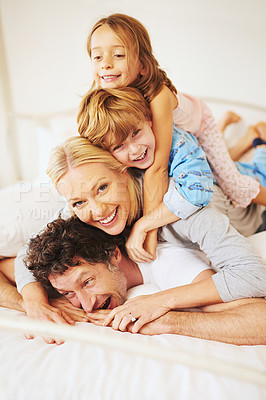 Buy stock photo Portrait, happy and family on bed with kids, parents and play for bonding in bedroom. Couple, children and smiles for together, love and support in home on weekend for relaxing, break and happiness