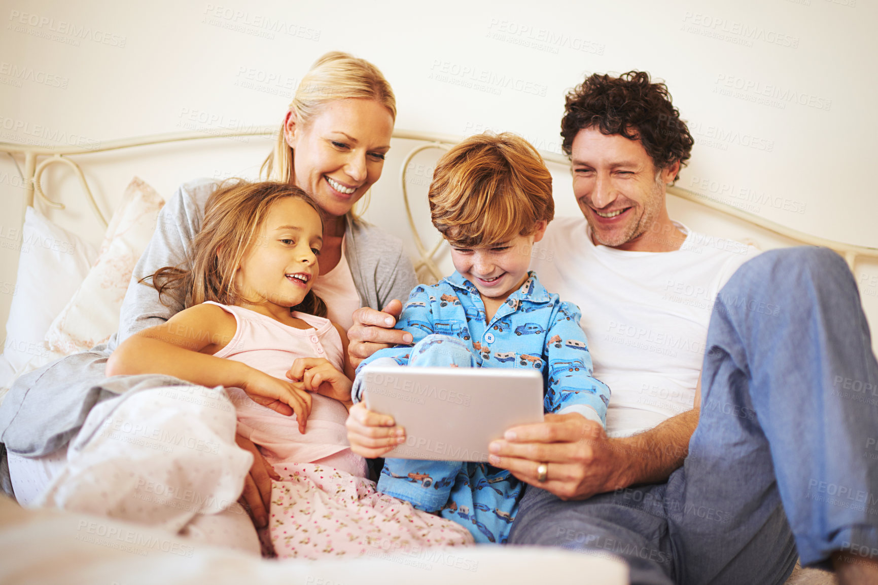 Buy stock photo Cropped shot of a family browsing on a digital tablet together at home