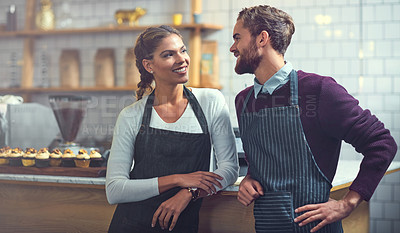 Buy stock photo Shot of two young business owners working in their store