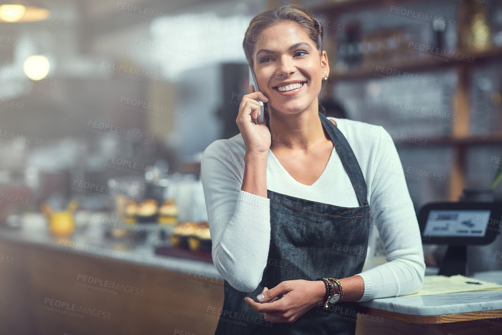 Buy stock photo Small business, woman and happy in restaurant with phone call, communication and stock order. Cafe owner, smile and feedback on mobile for customer service, inventory management and supplier contact