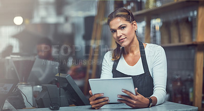Buy stock photo Portrait of a young woman using a digital tablet in the store that she works at