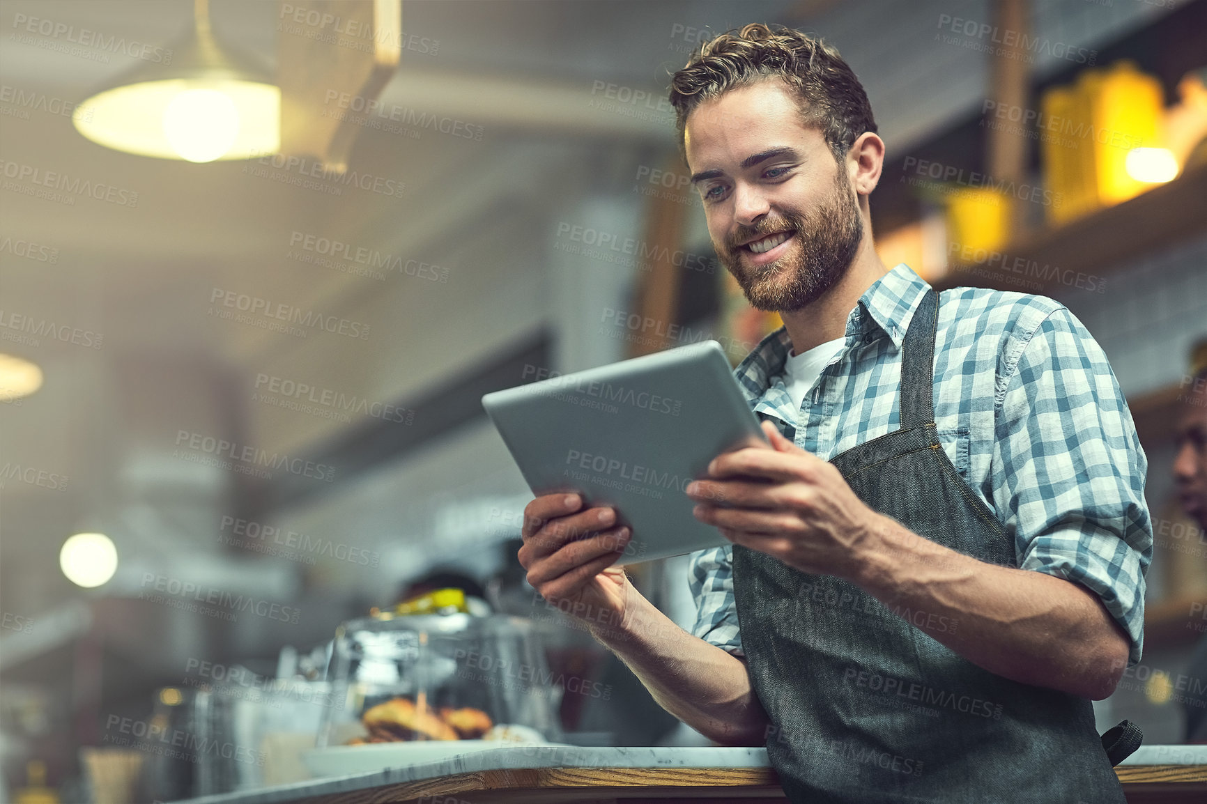 Buy stock photo Tablet, man and waiter in coffee shop with confidence for online menu update or stock control. Serving industry, cafe and male barista with digital technology for inventory report in restaurant.