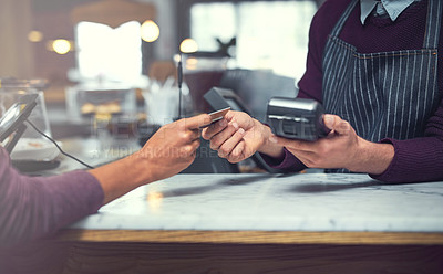 Buy stock photo Shot of a customer making a credit card payment at a cafe