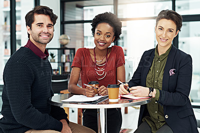 Buy stock photo Cropped portrait of a group of businesspeople meeting around a small table in their office
