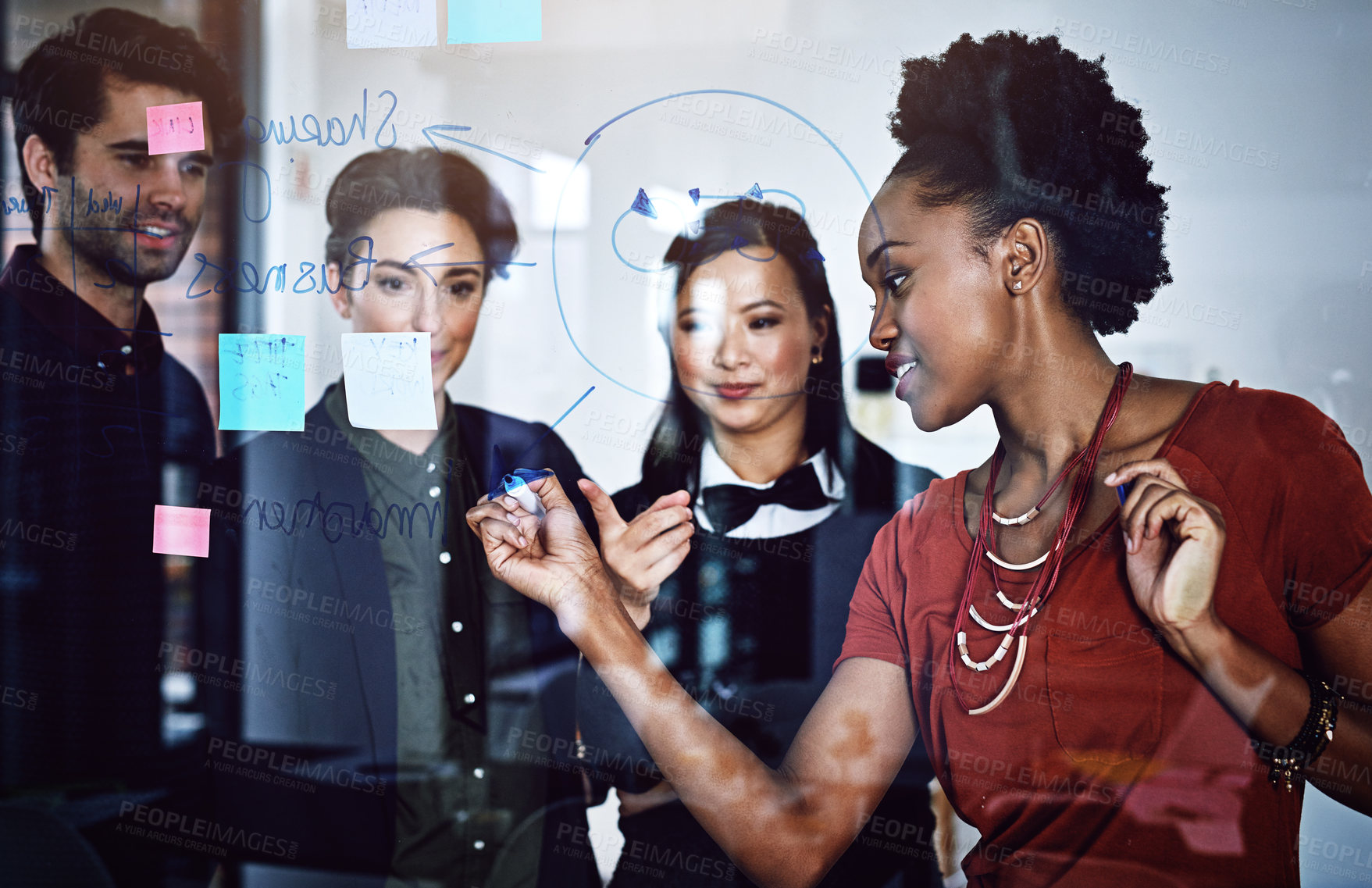 Buy stock photo Cropped shot of a group of businesspeople working on a glass wall the office