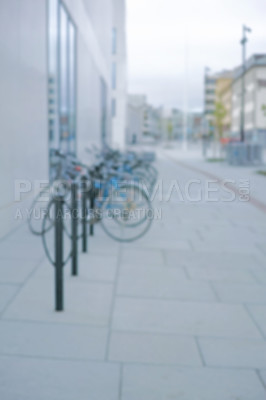 Buy stock photo Bike, row and rack in city, street and outdoor for hiring at shop for eco friendly travel in metro. Bicycle, sidewalk and urban path for transportation, sustainability and mobility on road in Germany