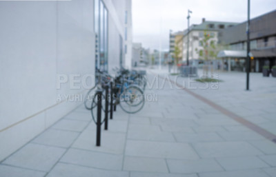 Buy stock photo Bike, row and rack in city, road and outdoor for hiring at shop for eco friendly travel in metro. Bicycle, sidewalk and urban path for transportation, sustainability and mobility on street in Italy