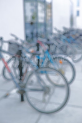 Buy stock photo Bike, parking rack and outdoor with row for eco friendly travel, security or sustainability with blur. Bicycle, street or urban sidewalk with transportation, carbon footprint and mobility in Spain