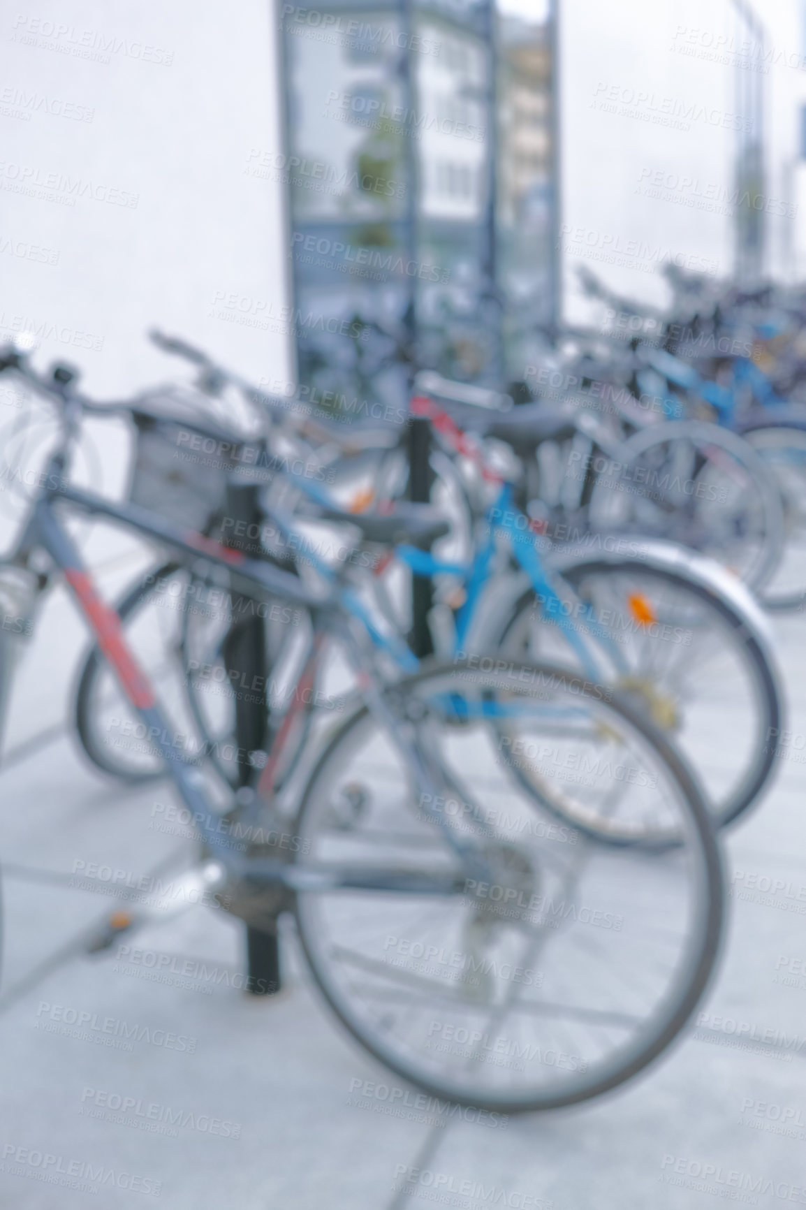 Buy stock photo Bicycle, parking rack and city with row for eco friendly travel, security and sustainability with blur. Bike, street and urban sidewalk with transportation, carbon footprint and mobility in Spain