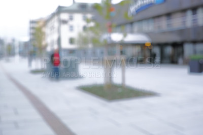 Buy stock photo Person, walking and city with blurry outdoor for travel vacation, urban explore and buildings on street. Architecture, shadow and road for infrastructure journey, adventure trip and holiday commute