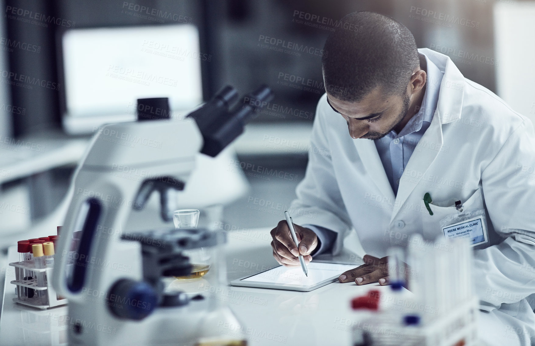 Buy stock photo Scientist, researcher and medical technician writing on a tablet, recording information and results in a lab. Focused and serious worker using technology for innovation and research in a laboratory