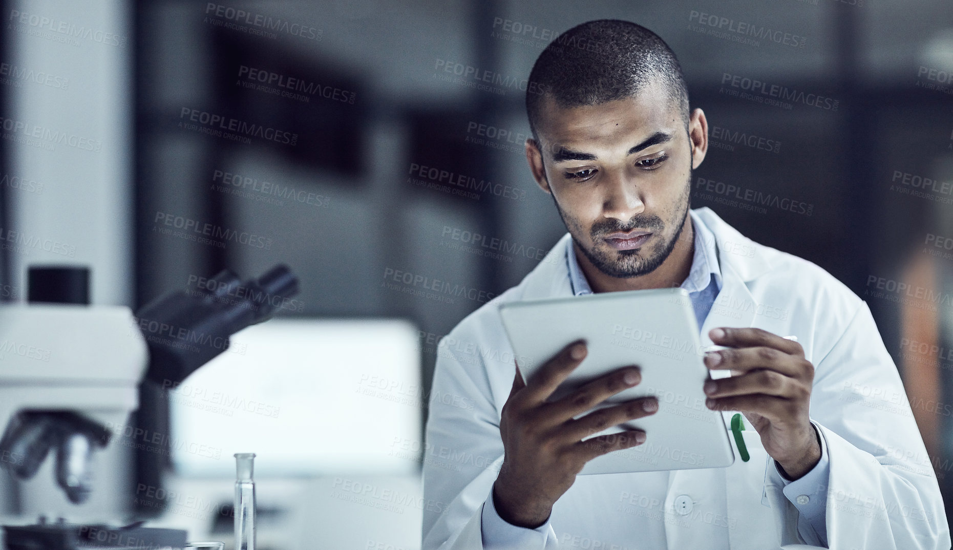 Buy stock photo Shot of a scientist recording his findings on a digital tablet