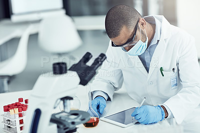 Buy stock photo Scientist, researcher and medical worker using a tablet for innovation and research while wearing a face mask in a lab. Male chemist working to find a cure for covid virus in a science facility 
