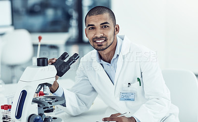 Buy stock photo Cropped shot of a young male scientist working in his lab