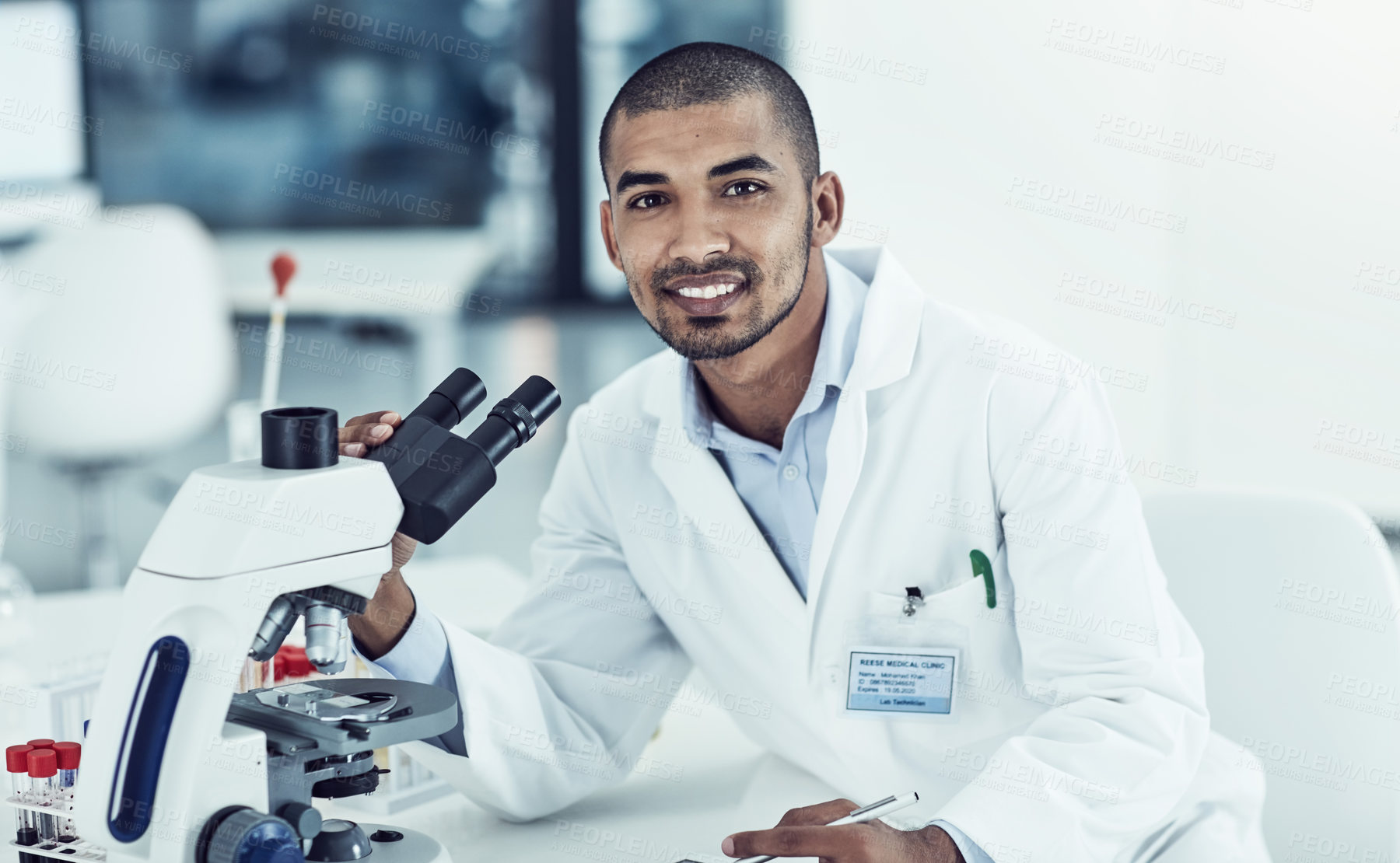 Buy stock photo Cropped shot of a young male scientist working in his lab