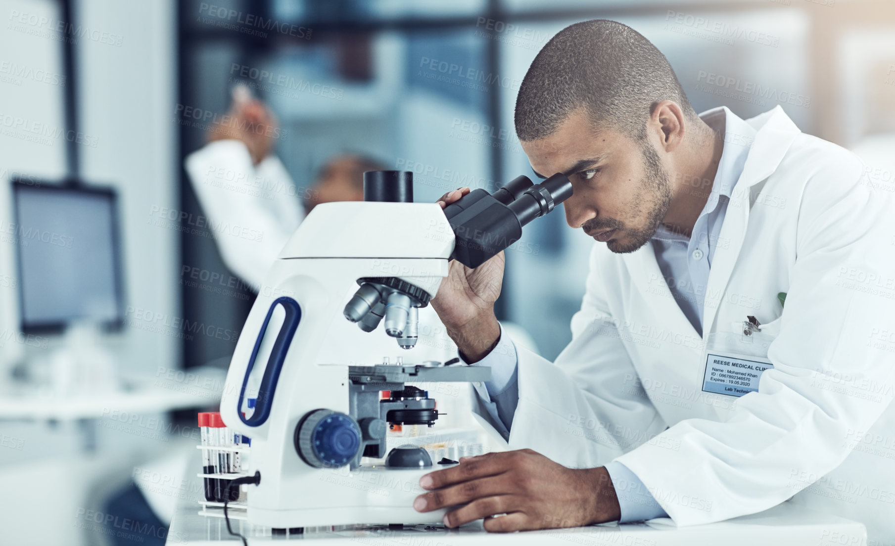 Buy stock photo Man, microscope and science at lab for test, assessment and blood sample for mpox vaccine development. Person, equipment and research for pharma innovation, medicine or drugs for healthcare crisis