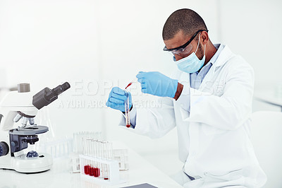 Buy stock photo Innovation, science and medical discovery in a lab with a male scientist working with medical samples. Leading health care professional conducting an experiment with blood, creating cure or treatment