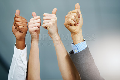Buy stock photo Cropped shot of a group of businesspeople's hands showing thumbs up in the office