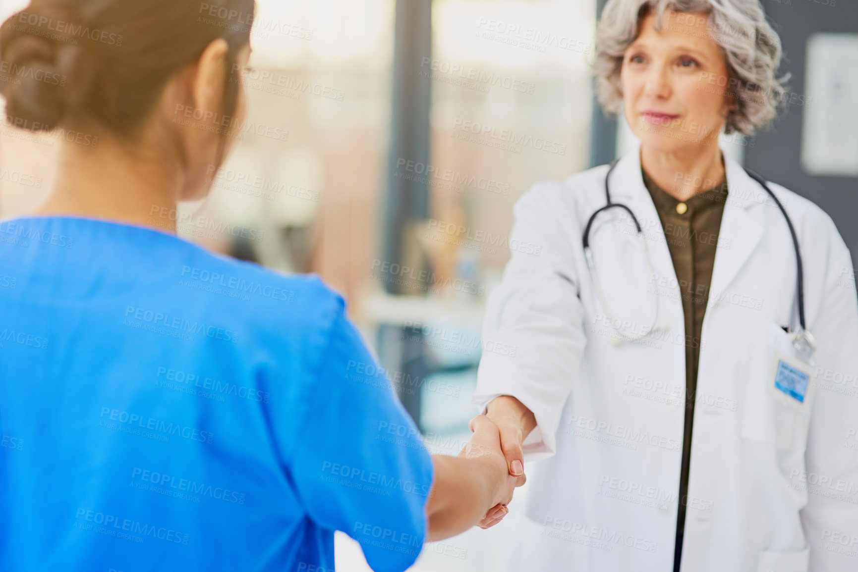 Buy stock photo Shot of a doctor and nurse shaking hands