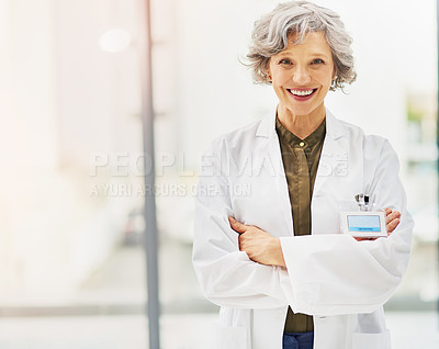 Buy stock photo Portrait of a confident and mature doctor folding her arms