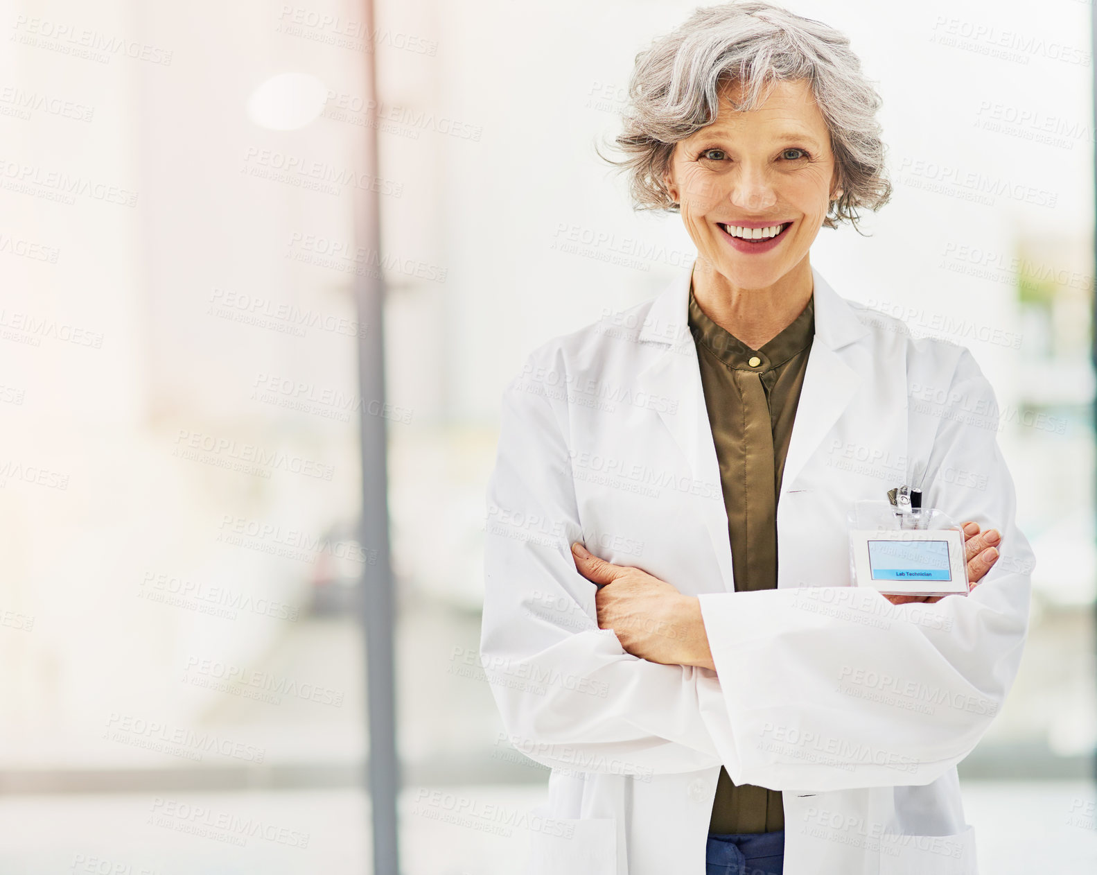 Buy stock photo Portrait of a confident and mature doctor folding her arms