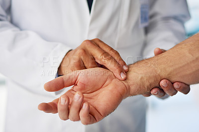 Buy stock photo Cropped shot of a doctor taking a patient’s pulse