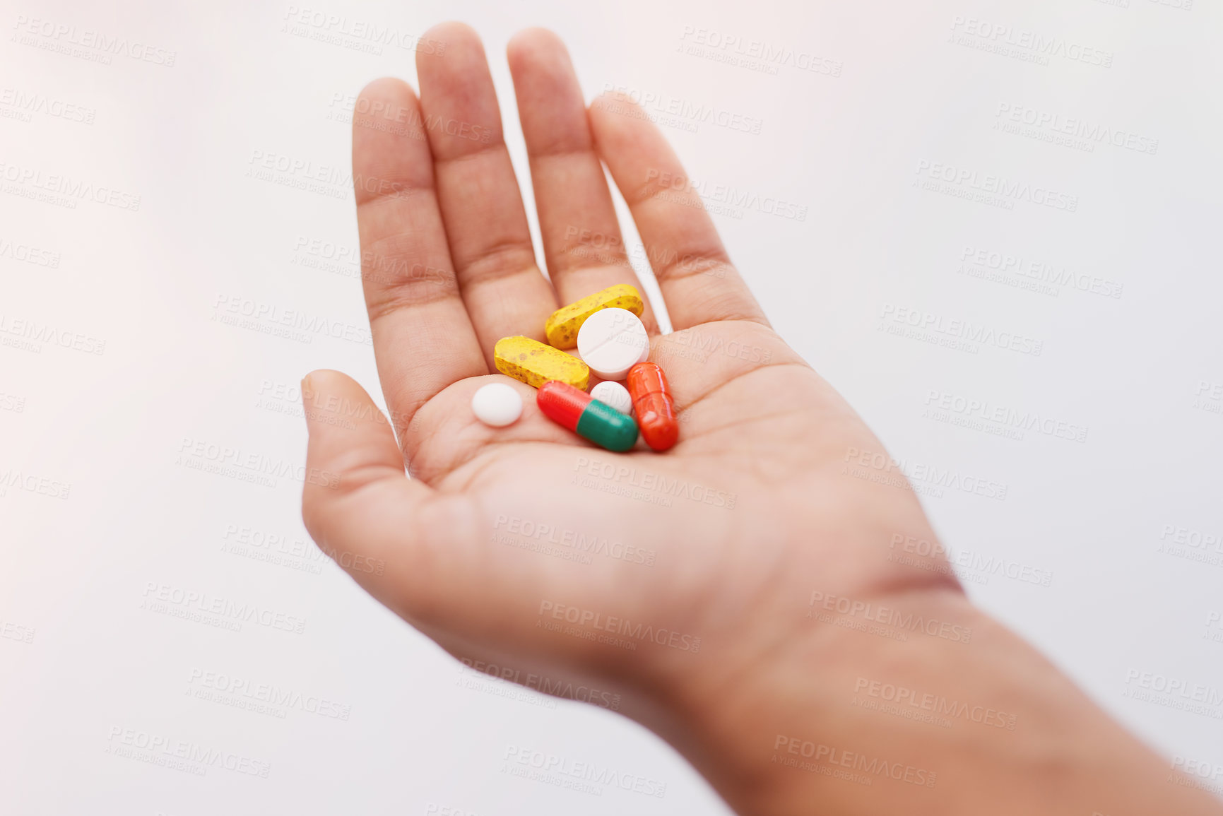 Buy stock photo Cropped shot of a hand holding an assortment of medication
