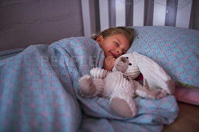 Buy stock photo Girl, sleep and teddy bear in bed for comfort, dream and  wellness at house by night with pillow. Female child, tired and stuffed animal in home for safe, peace and calm rest with blanket in bedroom