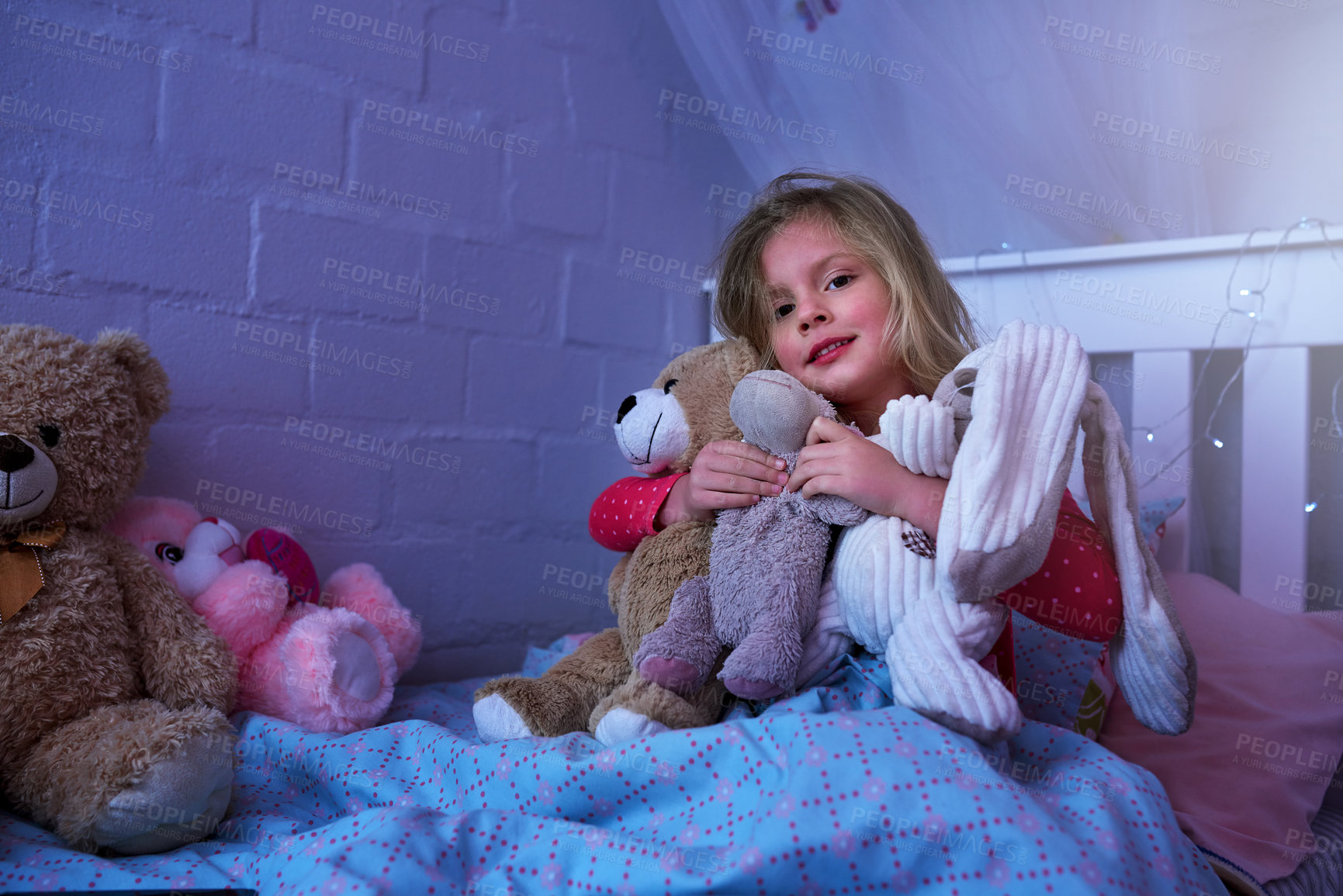 Buy stock photo Portrait of a little girl hugging her soft toys while sitting in bed