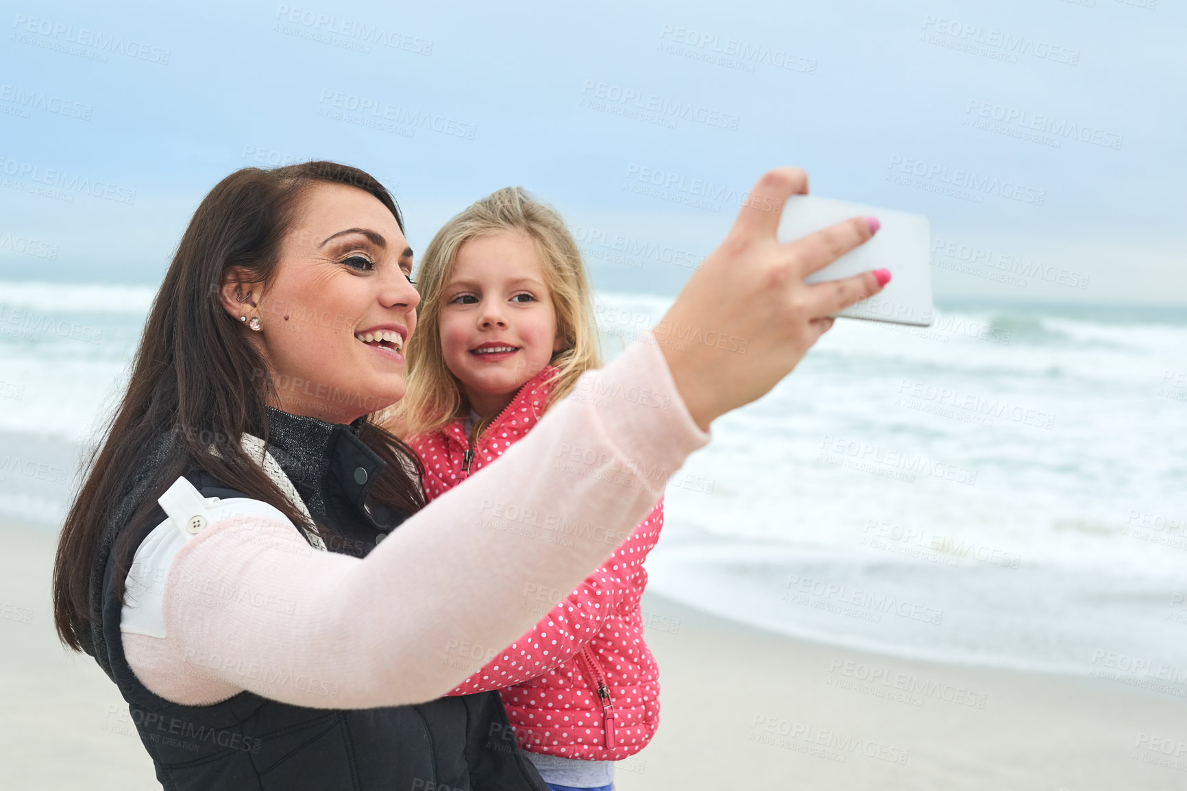 Buy stock photo Mother, child and selfie on beach for happiness, carefree and freedom by ocean in Australia. Female person, daughter and family by sea for bonding, good memory and enjoyment together on shore