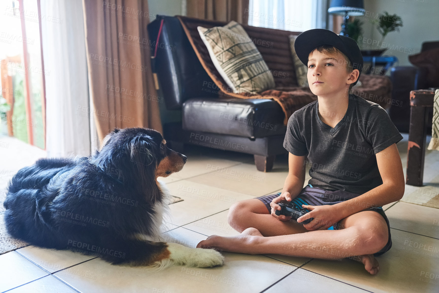 Buy stock photo Full length shot of a young boy playing video games at home