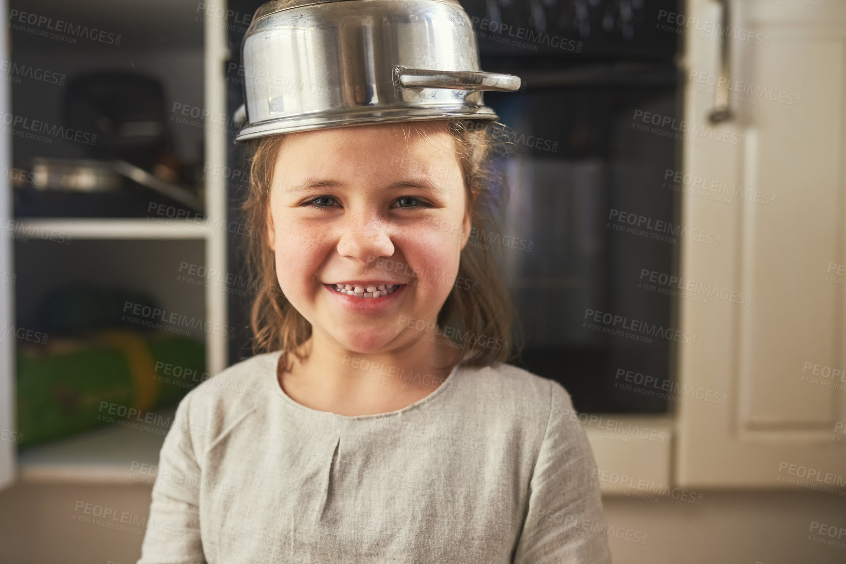 Buy stock photo Kitchen, pots and portrait of child in play with creativity on holiday or vacation. Kid, games and face of girl with container on head as helmet for safety, security and happy growth in family house