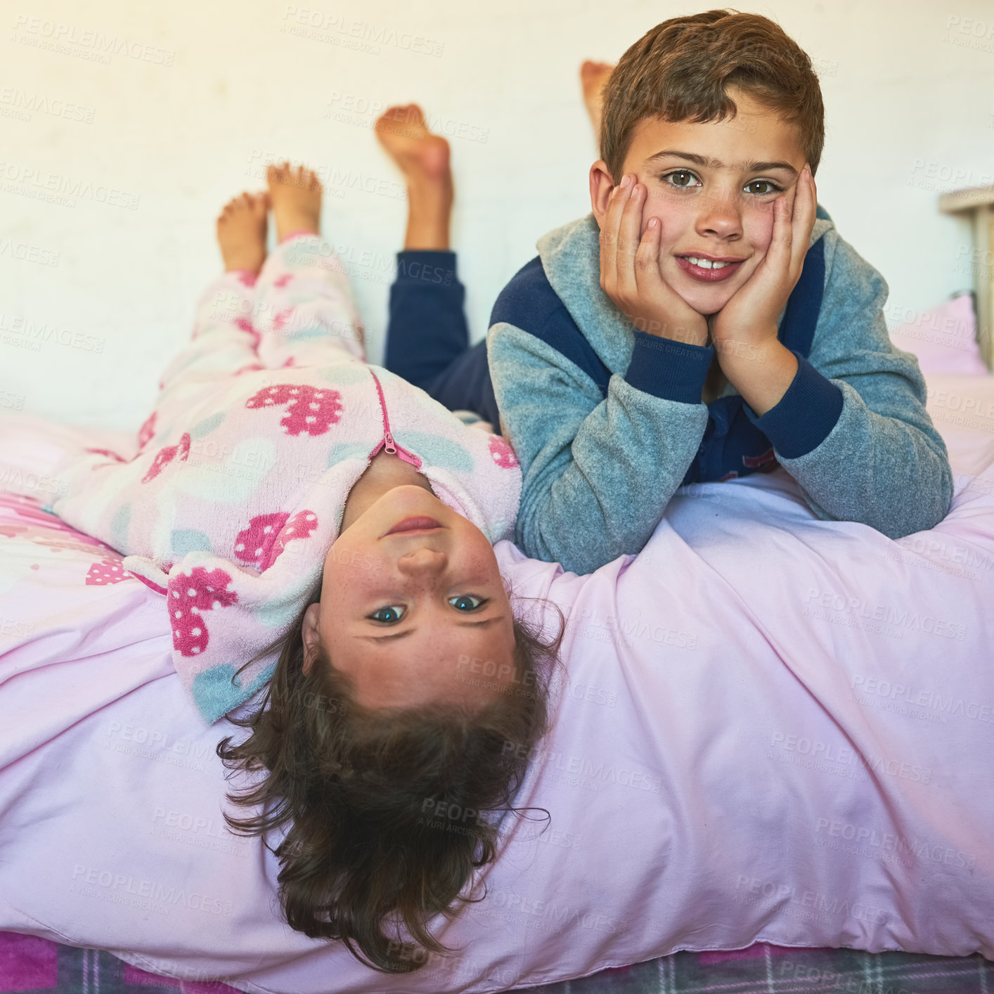 Buy stock photo Children, siblings and portrait with relax on bed in home for playing, bonding and rest on weekend. People, brother and sister with smile in bedroom with comfort, enjoyment and innocent fun in house