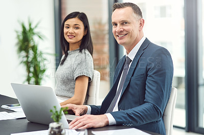 Buy stock photo Portrait of two businesspeople sitting together in an office