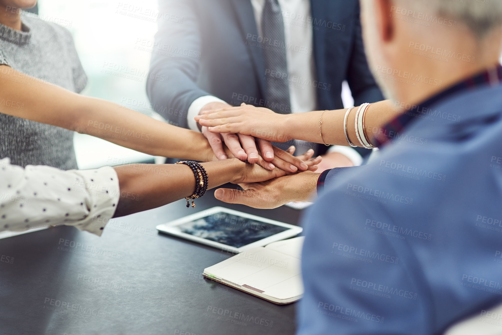 Buy stock photo Cropped shot of businesspeople joining their hands together in unity