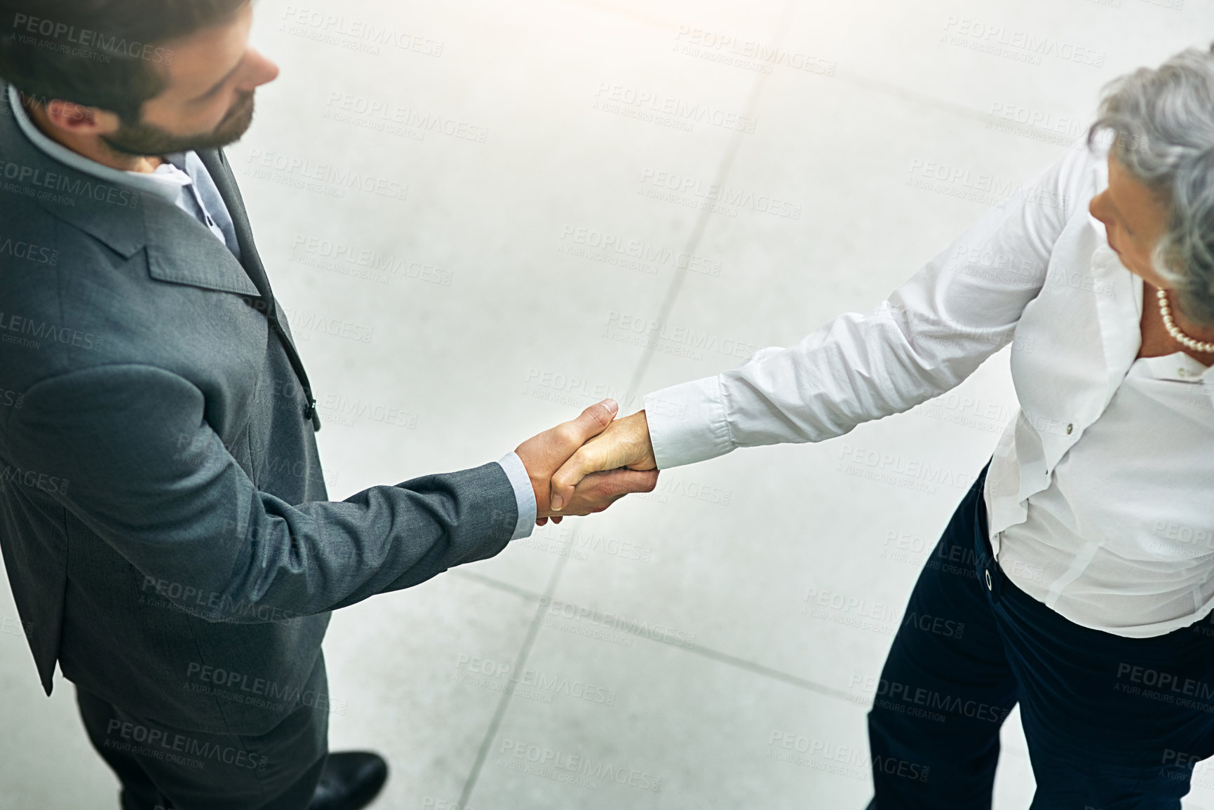 Buy stock photo Business people, handshake and meeting with partnership for b2b, greeting or agreement about at office. Top view of businessman, woman or employees shaking hands for teamwork or deal at workplace